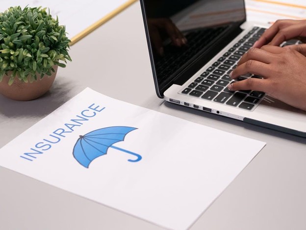 Busines Income Insurance - Typing the details on a laptop.